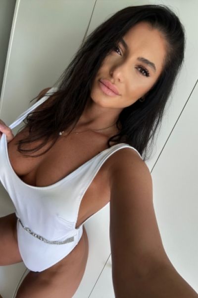 Brunette escort Kylies selfie of her in a white body 